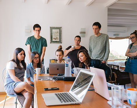 Team reviewing a web application on laptops